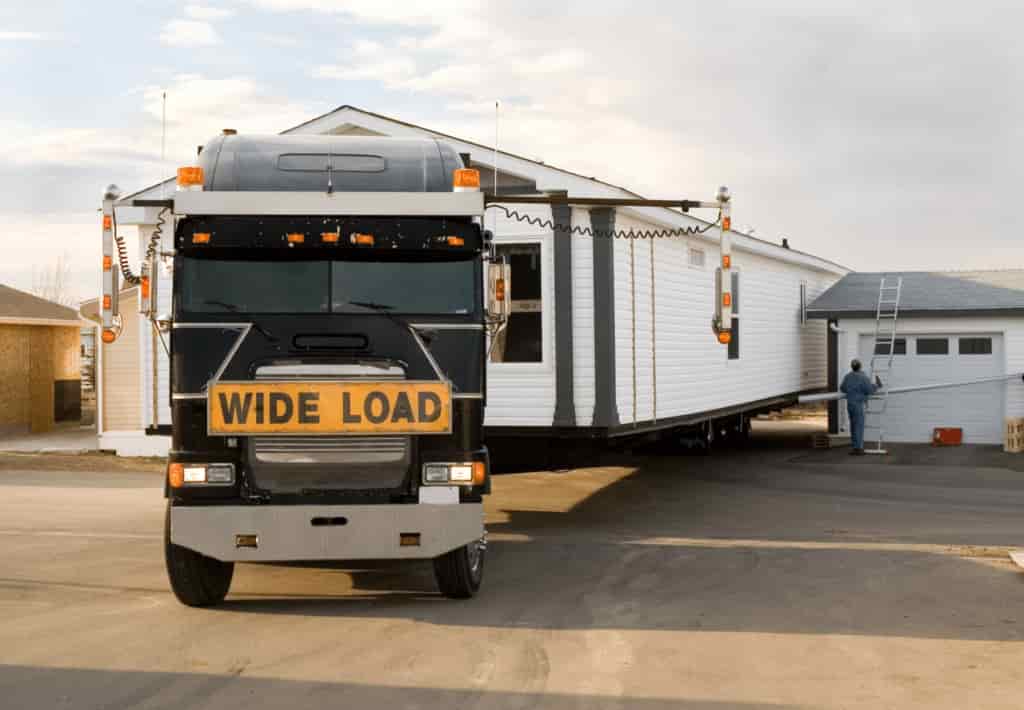 This is a photo of a transport truck on the way to relocate a mobile home. This is carried out by Mobile Home Movers Mississippi